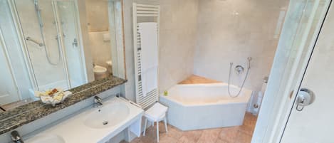 A modern bathroom with two sinks, a large mirror, a shower, and a bathtub.
