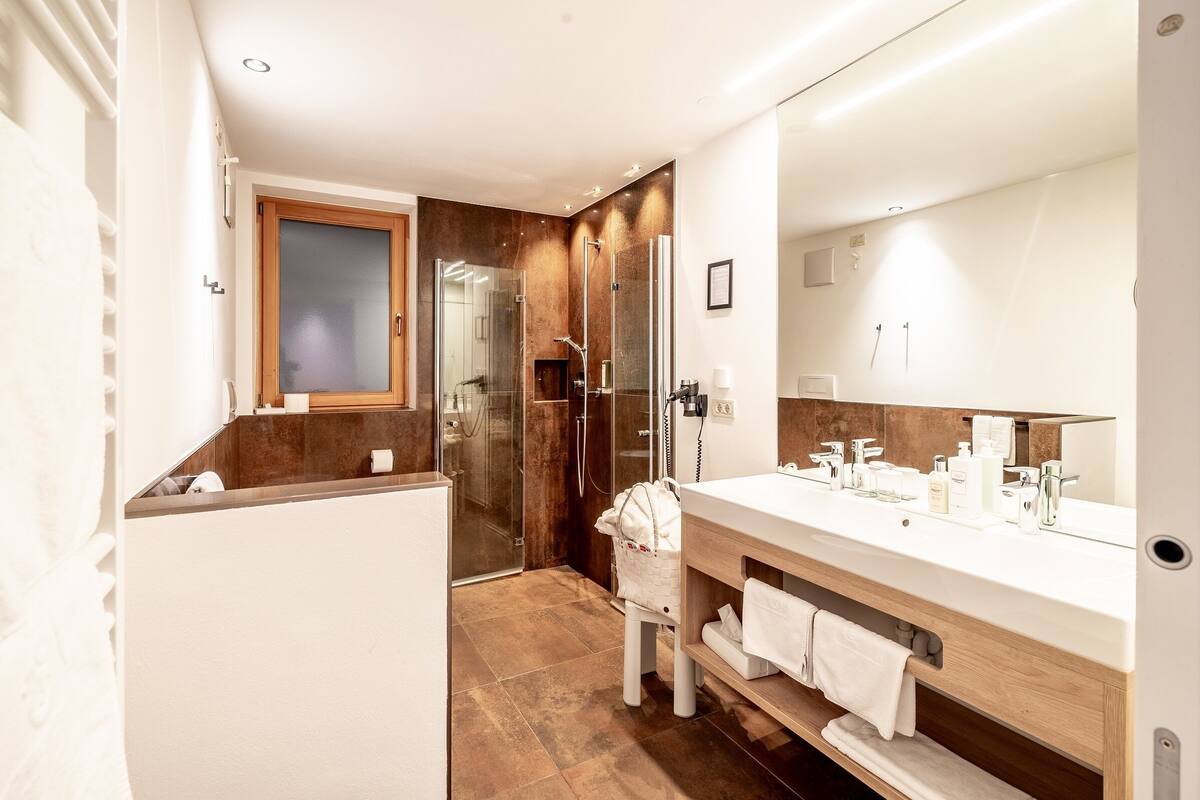 senior suite | bathroom | eco-friendly toiletries, hair dryer, bathrobes, slippers