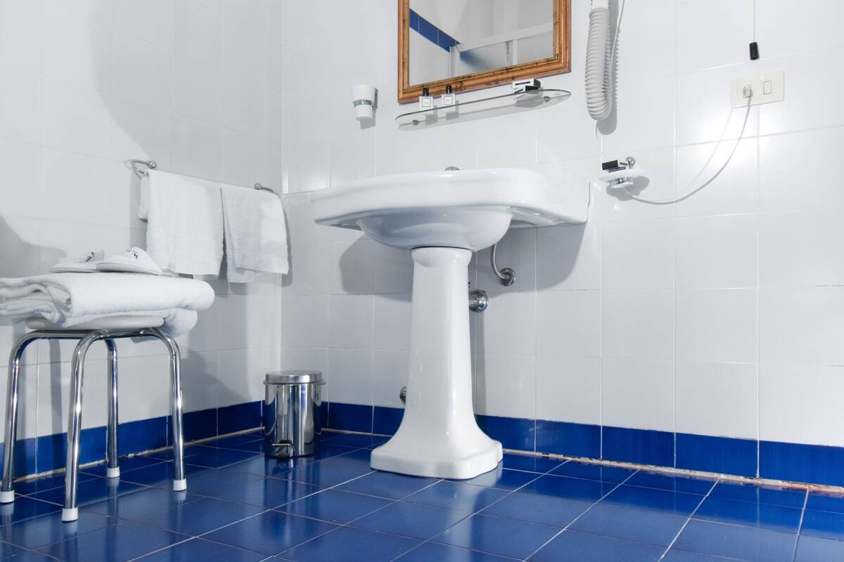 shower, designer toiletries, hair dryer, slippers