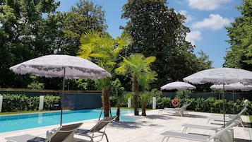 Seasonal outdoor pool, an infinity pool, pool umbrellas, sun loungers