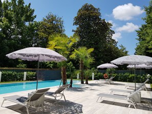 Seasonal outdoor pool, an infinity pool, pool umbrellas, pool loungers