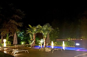 Seasonal outdoor pool, an infinity pool, pool umbrellas, pool loungers