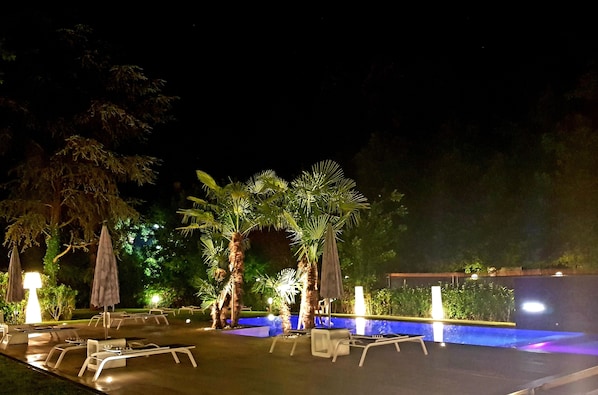 Seasonal outdoor pool, an infinity pool, pool umbrellas, pool loungers