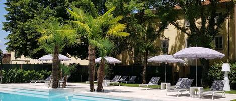 Seasonal outdoor pool, an infinity pool, pool umbrellas, sun loungers