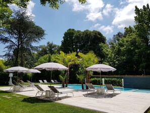 Seasonal outdoor pool, an infinity pool, pool umbrellas, pool loungers