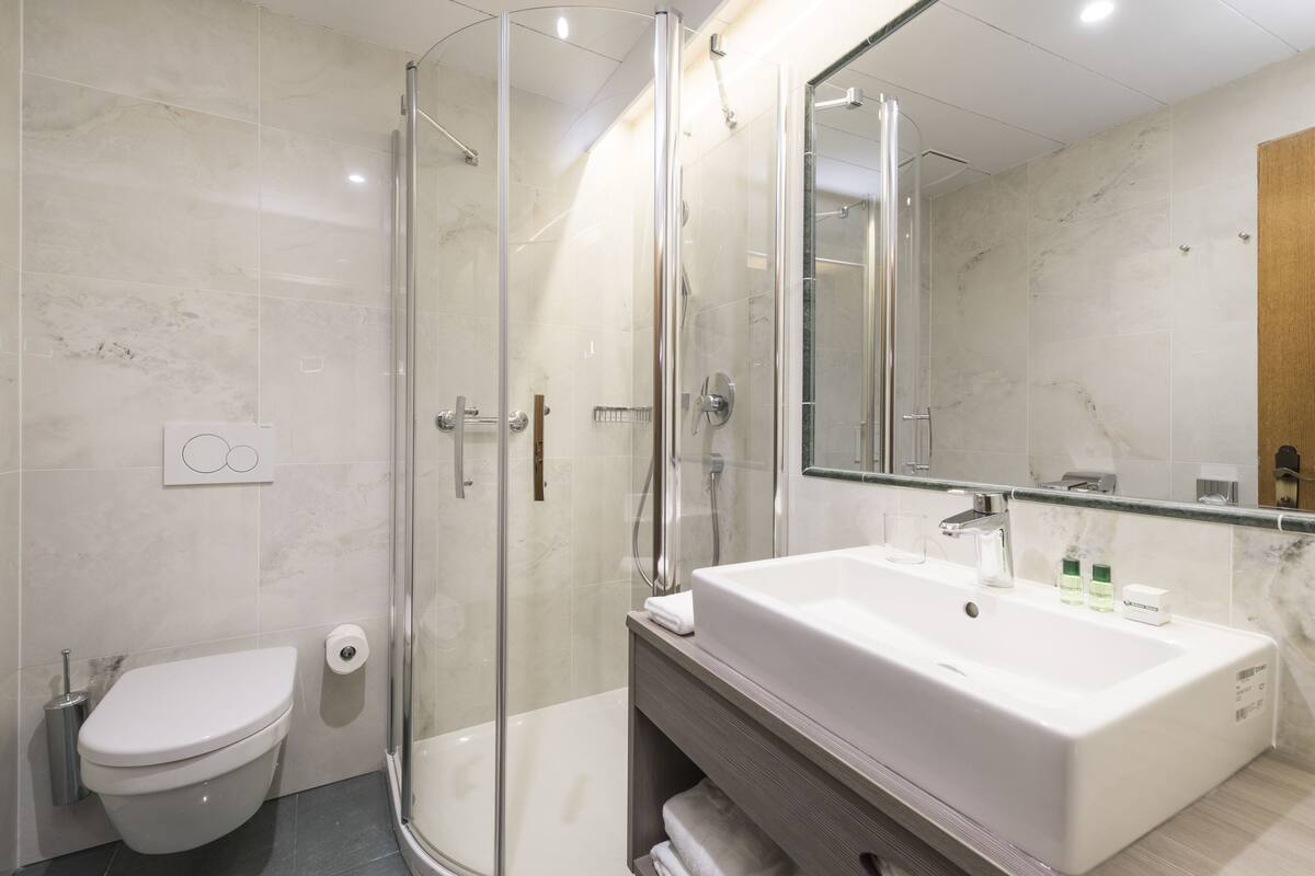 comfort single room | bathroom | hair dryer, slippers, towels