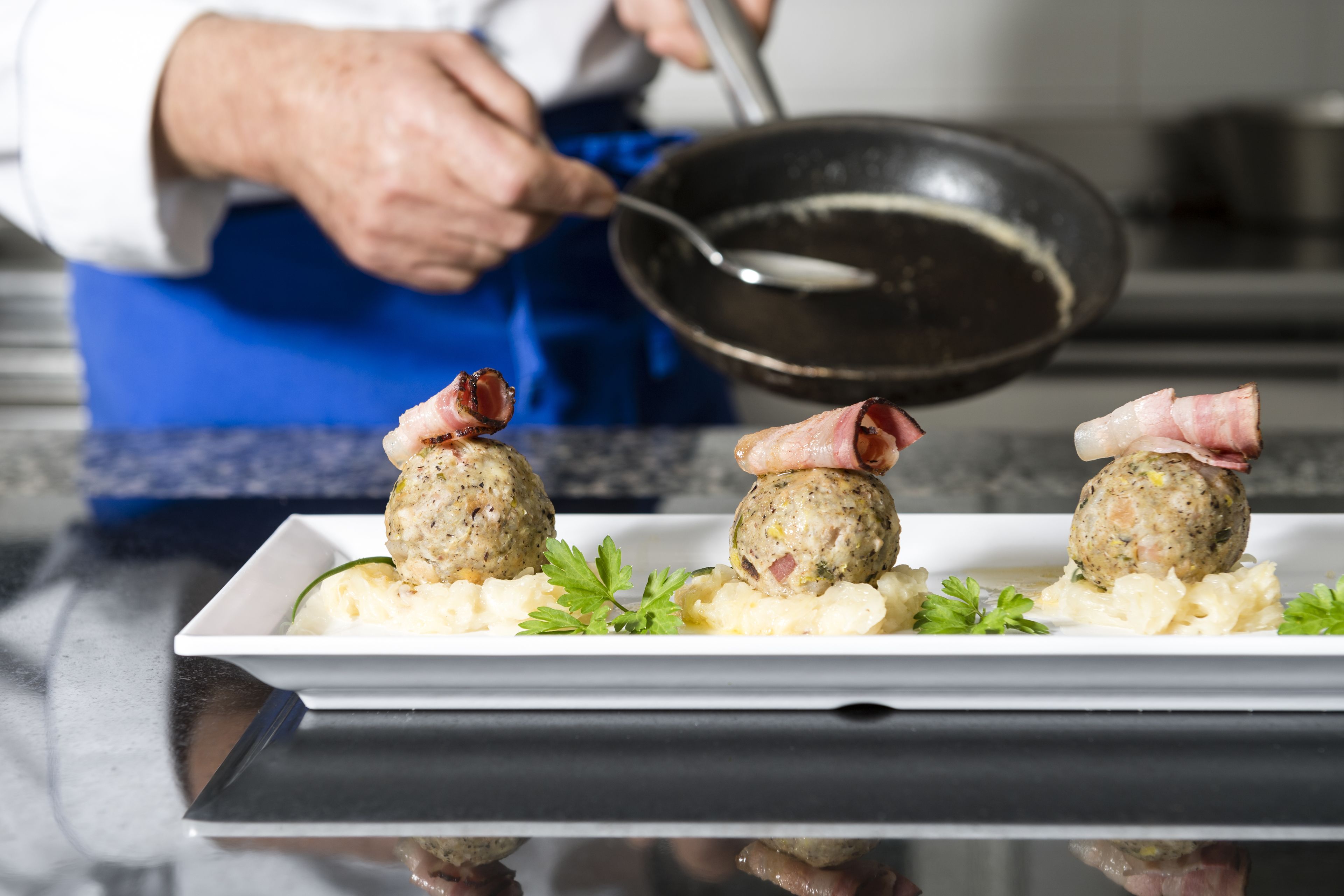 A chef preparing food in a kitchen.