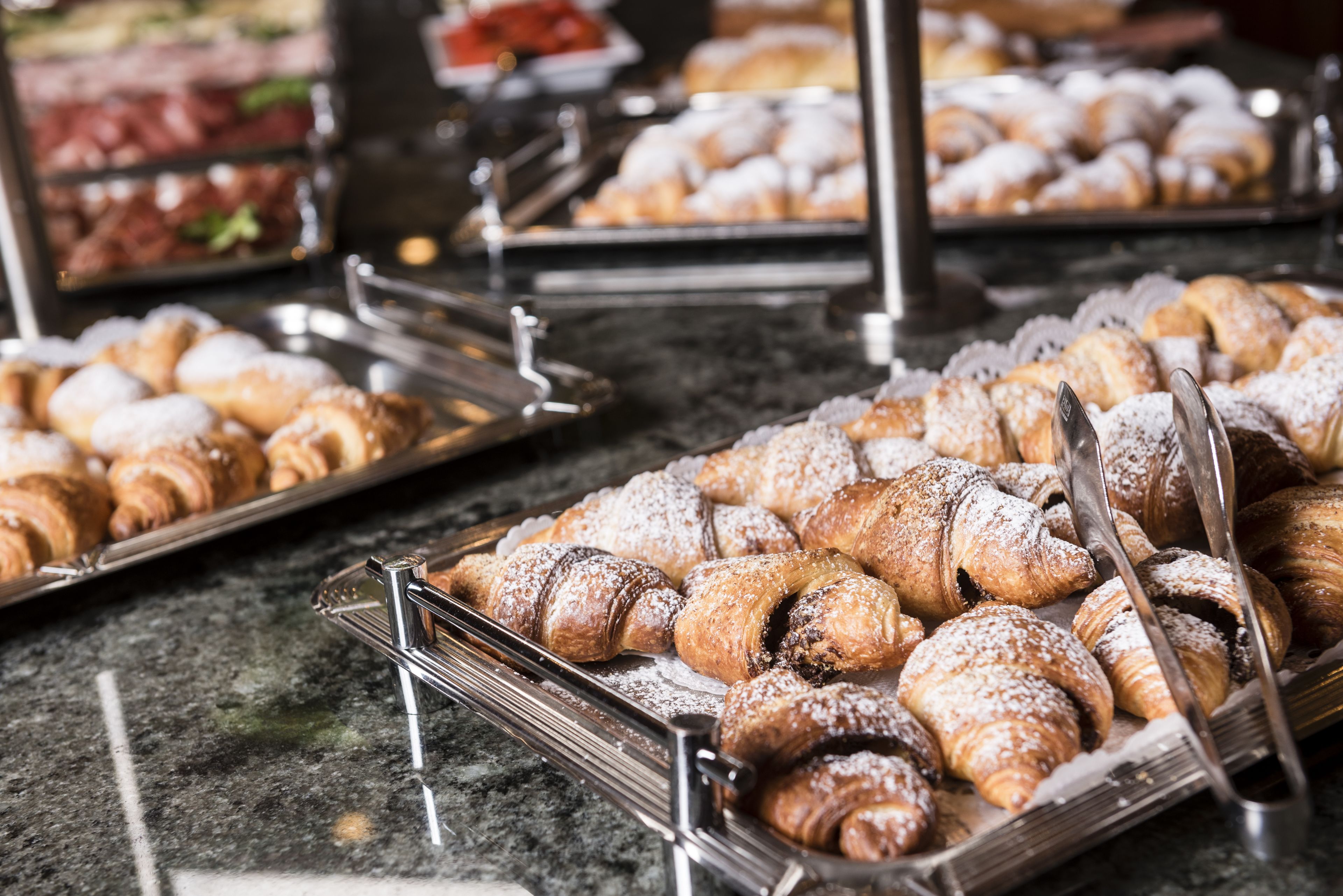 A buffet with various pastries and desserts.