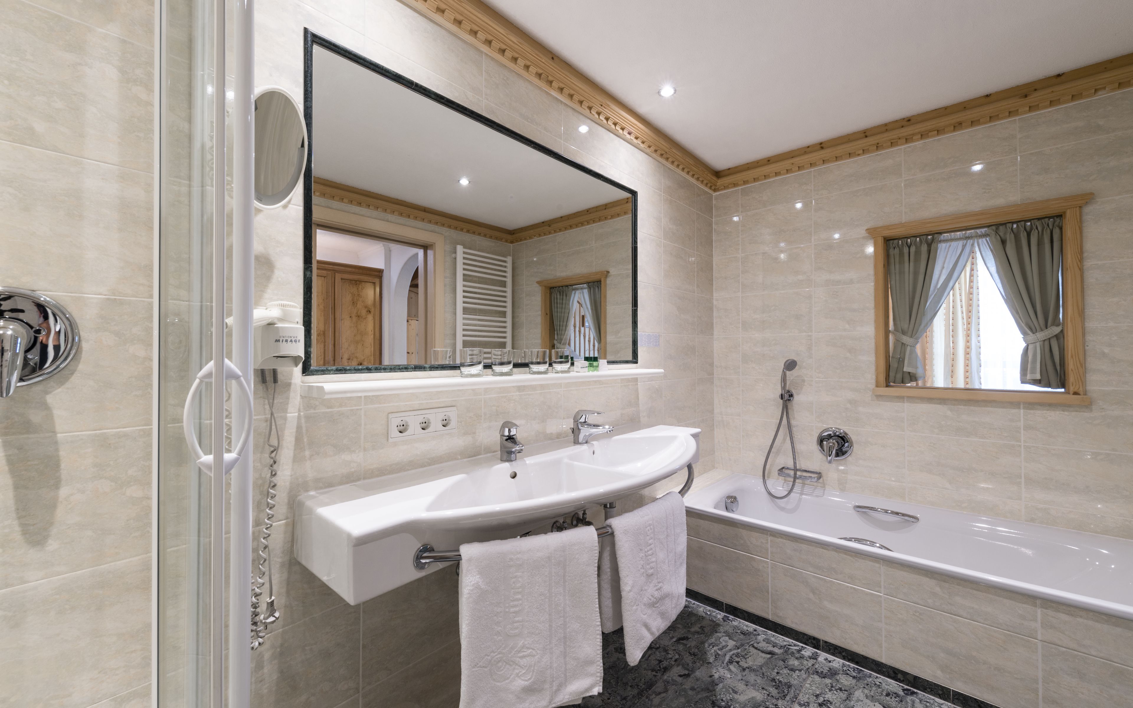 junior suite | bathroom | hair dryer, slippers, towels