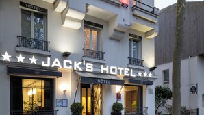 A hotel facade with "JACK'S HOTEL" signage, multiple balconies, and a well-lit entrance. - Jack's Hotel (Paris)