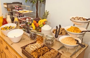 A buffet with various food items and condiments. - Baggot Court Townhouse (Dublin)