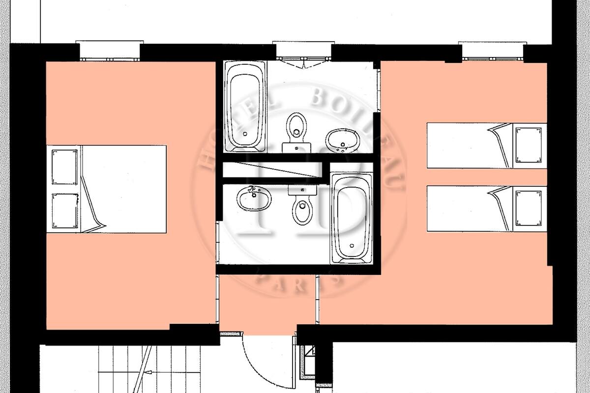 A floor plan of a hotel with a central bathroom, two bedrooms, and a kitchenette.