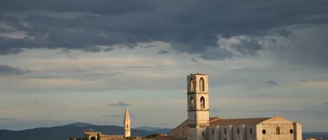 A historic town with a prominent church featuring a tall bell tower and a cathedral with a large arched entrance.