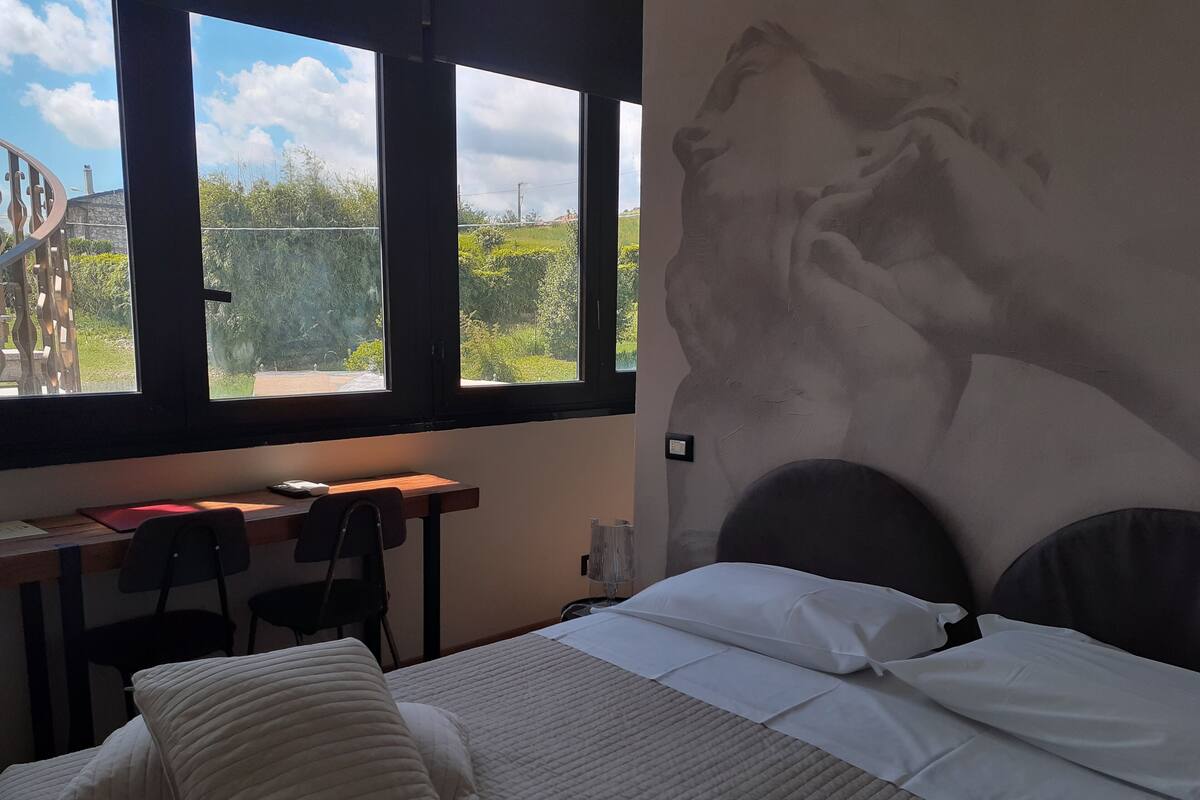 Une chambre à coucher avec un lit, un bureau et une fenêtre.