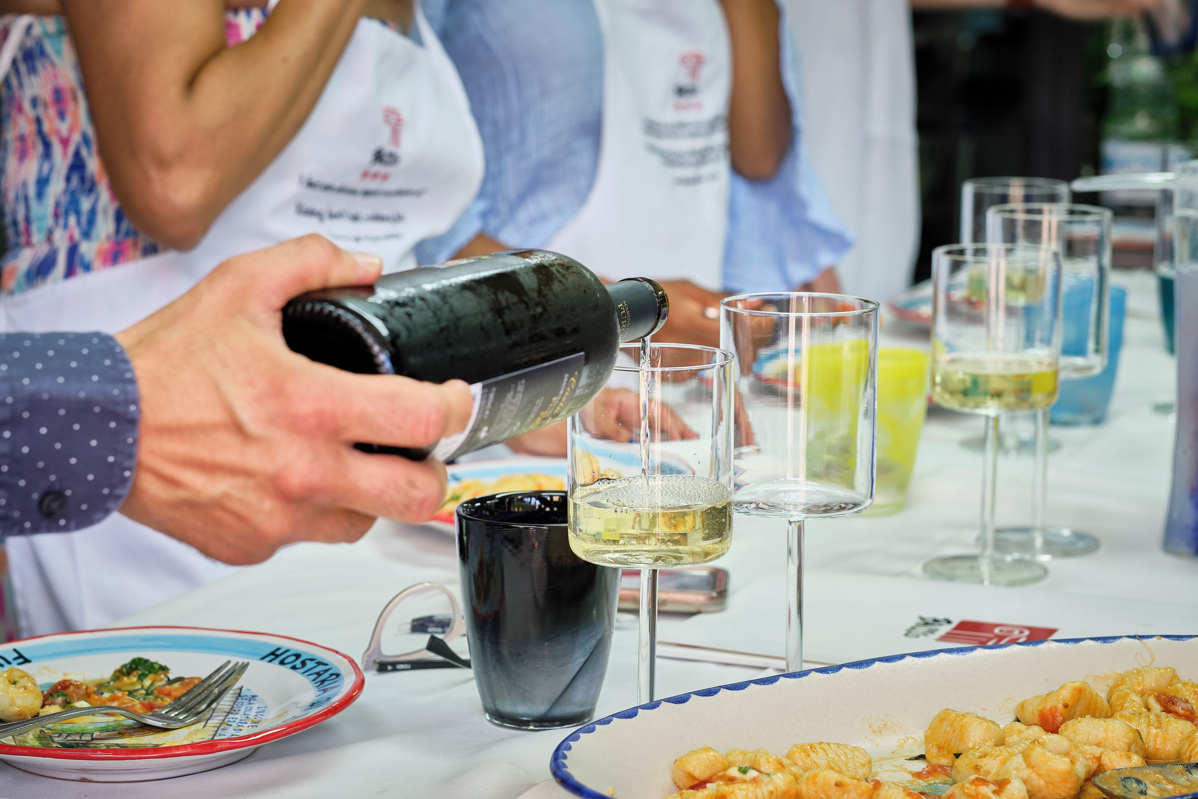 A person pouring a drink into a glass.