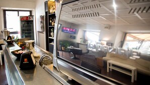 A modern kitchen with a stainless steel espresso machine, a coffee grinder, and a digital display. - Bes Hotel Papa San Pellegrino Terme (San Pellegrino Terme)