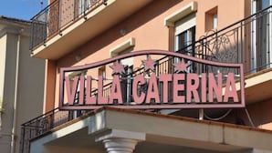 A sign for "Villa Caterina" with a classic architectural design, featuring a balcony with ornate railings and a clear view of the building's facade. - Hotel Villa Caterina (Rimini)