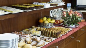 Un buffet con diversi piatti e una composizione floreale decorativa.