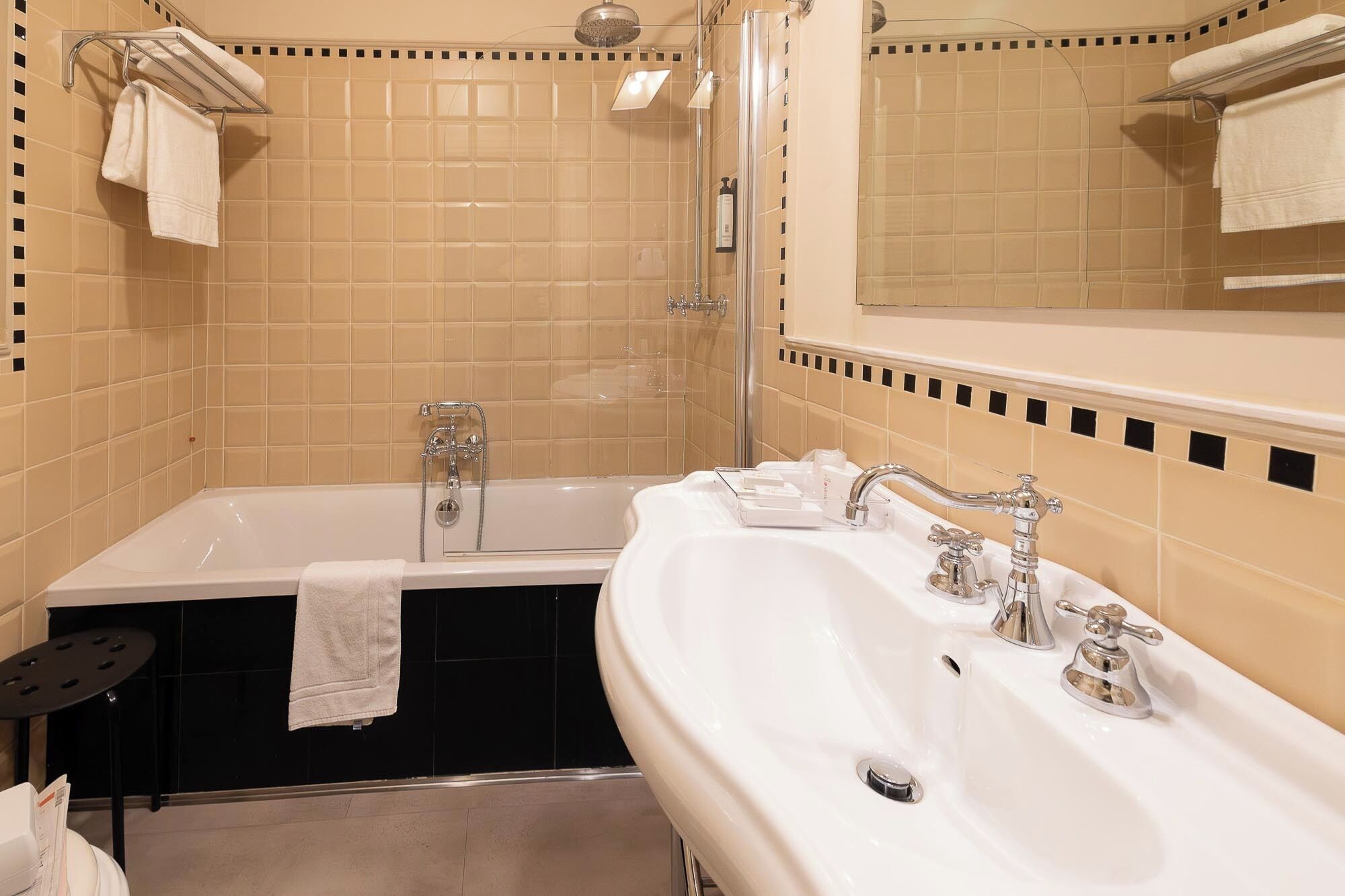 A bathroom with a bathtub, a shower, and a sink.