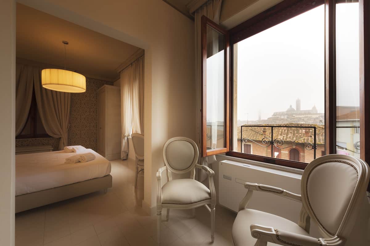 Junior Suite, City View | 1 bedroom, down duvets, minibar, in-room safe