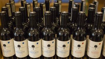 A collection of wine bottles with labels indicating they are from the Chianti and Rosso varieties, produced in 2015.
