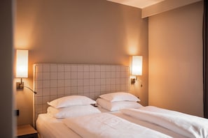 Economy Double Room | Minibar, in-room safe, desk, blackout drapes