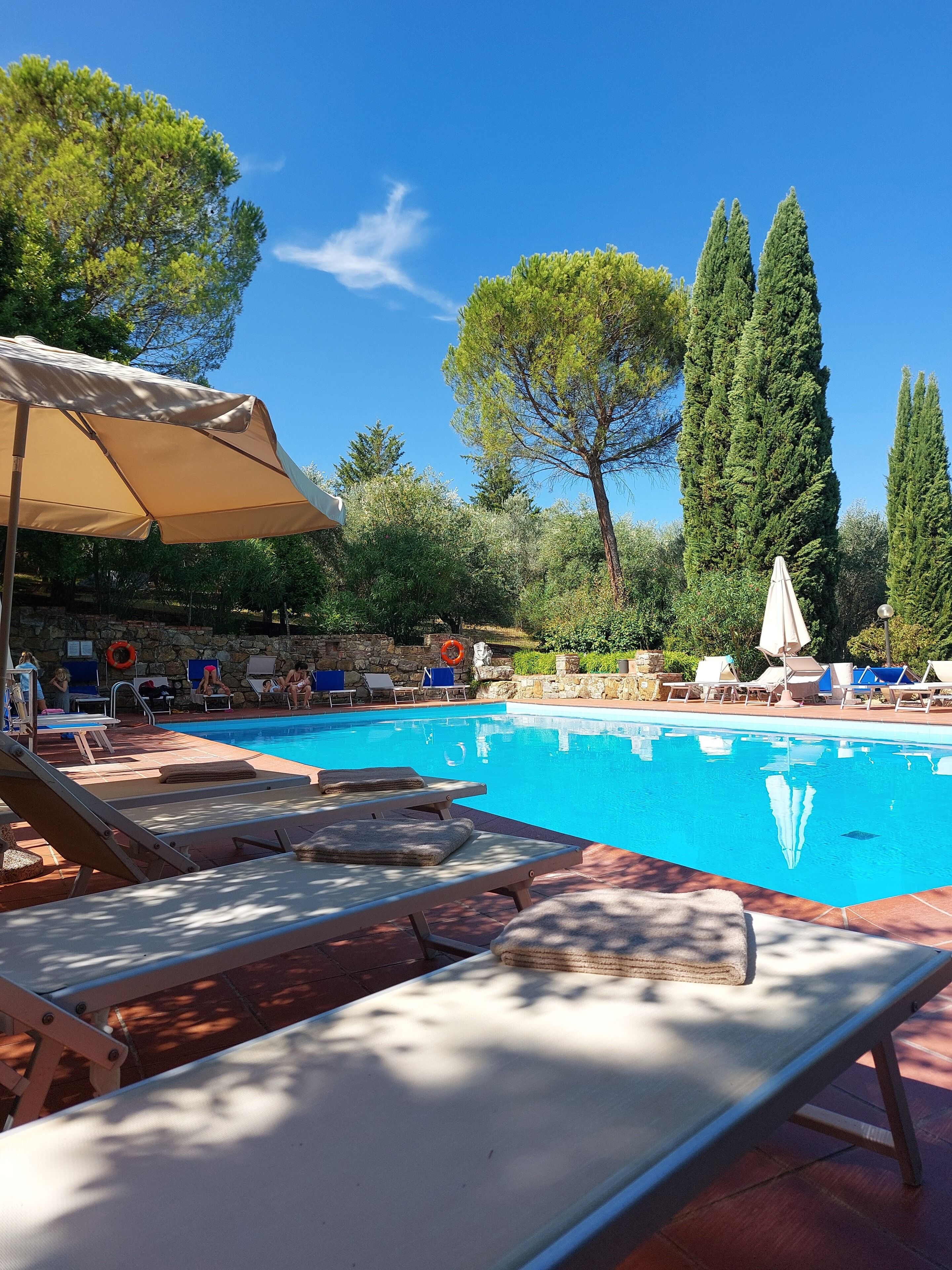 Seasonal outdoor pool, open 9:00 AM to 8:00 PM, pool umbrellas