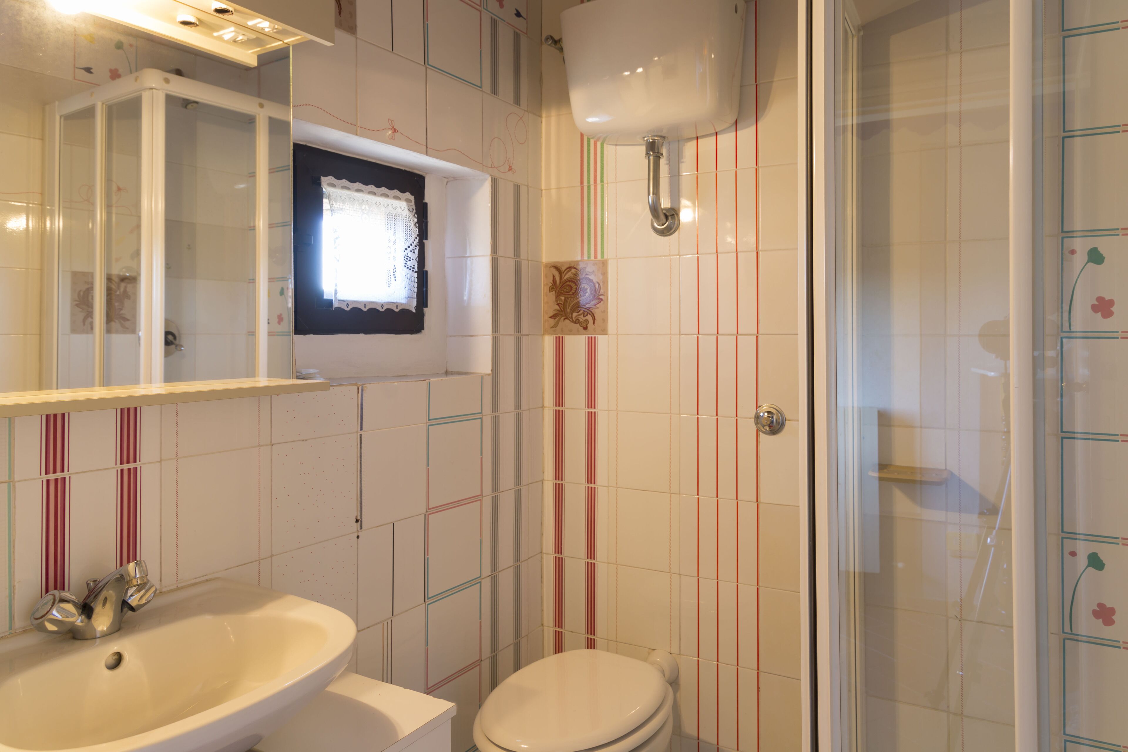 A bathroom with a sink, toilet, and shower.