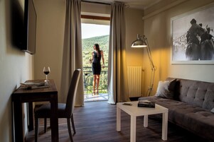 Suite, balcone, vista collina | Area soggiorno | TV a schermo piatto