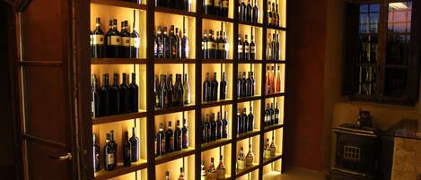 A wine cellar with shelves of wine bottles.