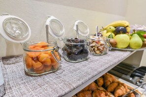 A buffet with various food items including fruits, nuts, and pastries. - Hotel Bella Firenze (Florence)