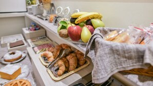 A buffet with fruits, pastries, and a variety of food items. - Hotel Bella Firenze (Florence)