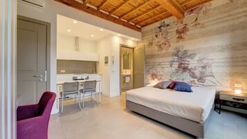 A bedroom with a bed, a desk, and a chair.