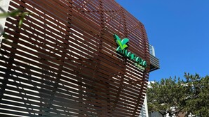 A hotel with a pool area, a modern facade with horizontal wooden slats, and a visible logo. - Hotel Anapaya (Lignano Sabbiadoro)