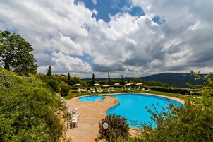 Outdoor pool, a rooftop pool, pool umbrellas, sun loungers