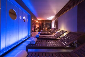 A spa area with wooden loungers, a wall with circular cutouts, and a calming ambiance. - Villa le Magnolie (Montecatini Terme)