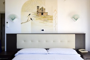 A hotel room with a large bed, a headboard, and a wall mural. - Hotel Bellavista (Rome)