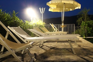 Seasonal outdoor pool, a rooftop pool, pool umbrellas, pool loungers