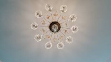 A ceiling with a central circular design surrounded by multiple arms, each ending in a clear, crystal-like structure.