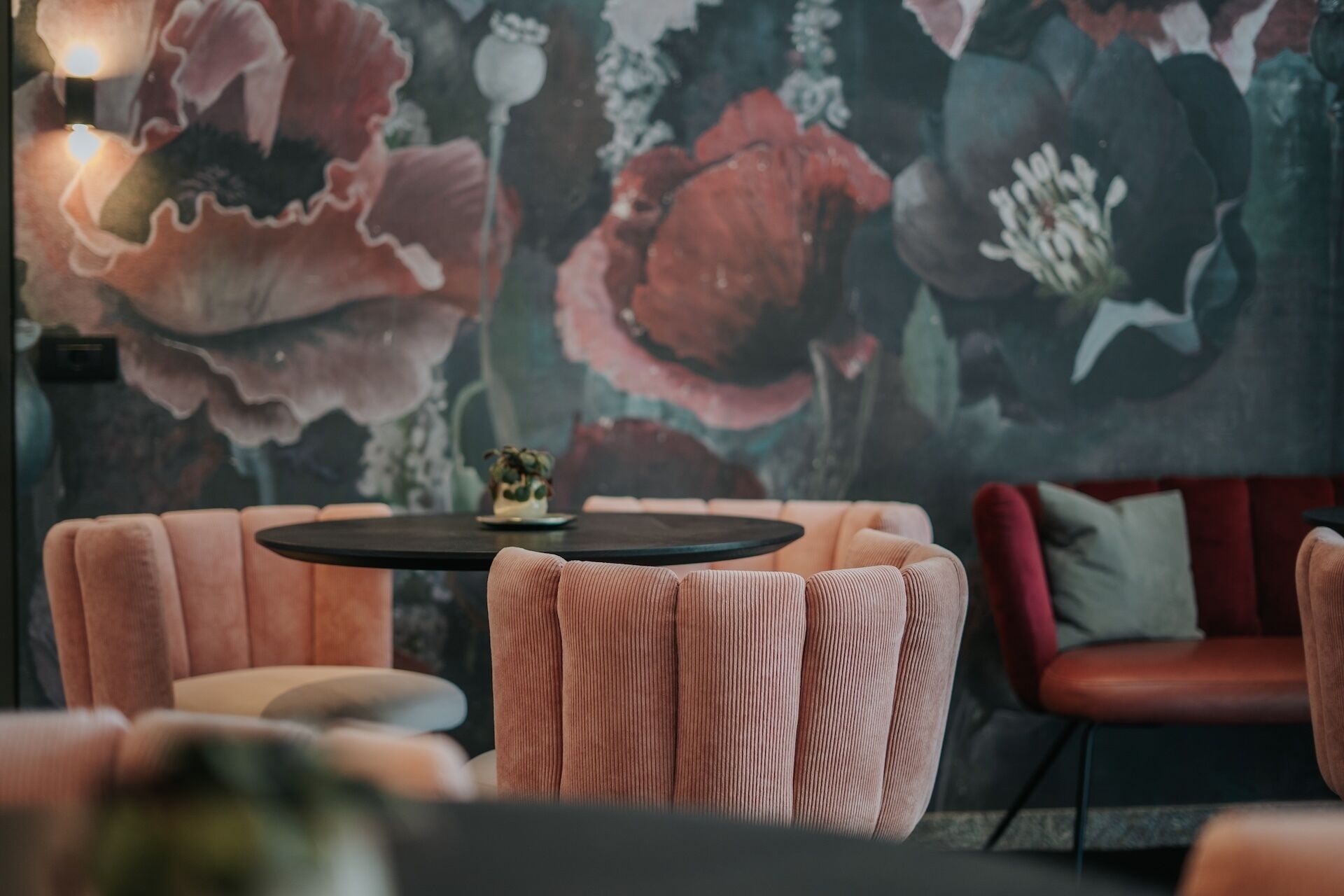 A cozy seating area with a round table and a potted plant.