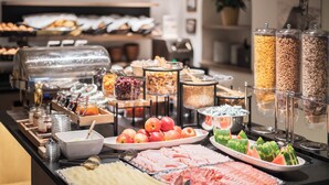 A buffet with various food items including fruits, meats, and cereals. -  Hotel Platz (Castelrotto)