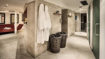 Enjoy a serene bathroom retreat with a large mirror, bench, and ample storage.