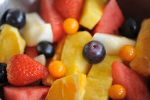 A close-up of a fruit salad with strawberries, blueberries, watermelon, and orange segments.