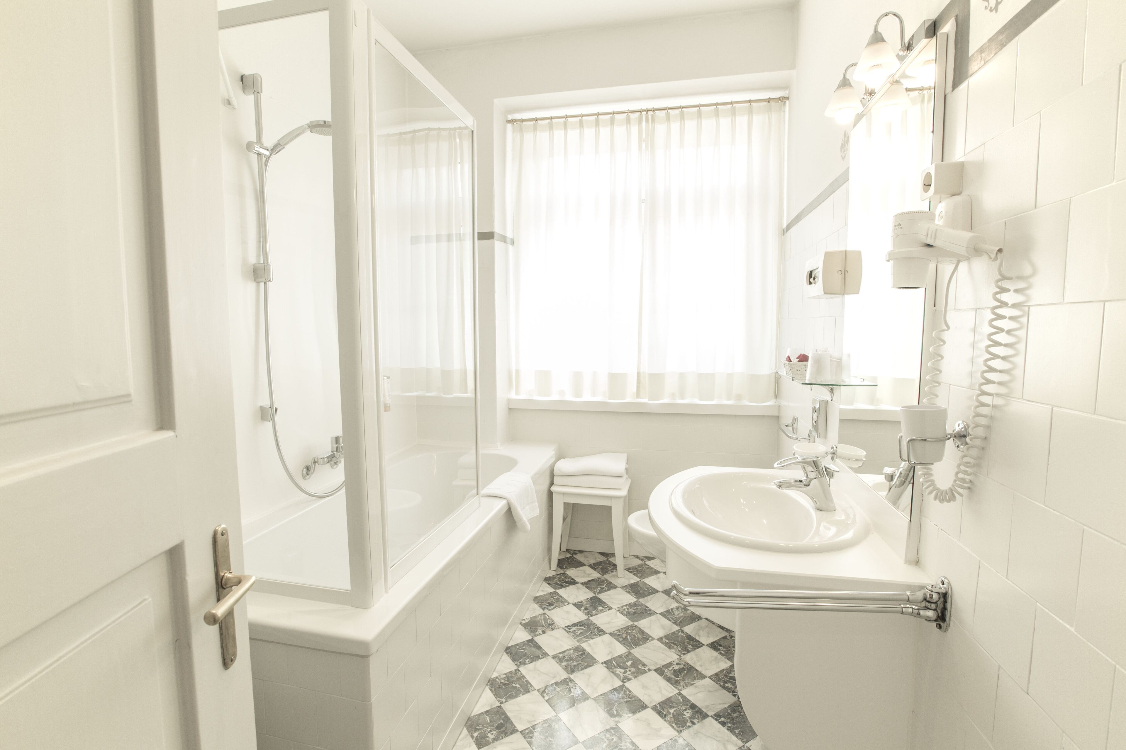 Une salle de bain avec une baignoire, une douche et un lavabo.