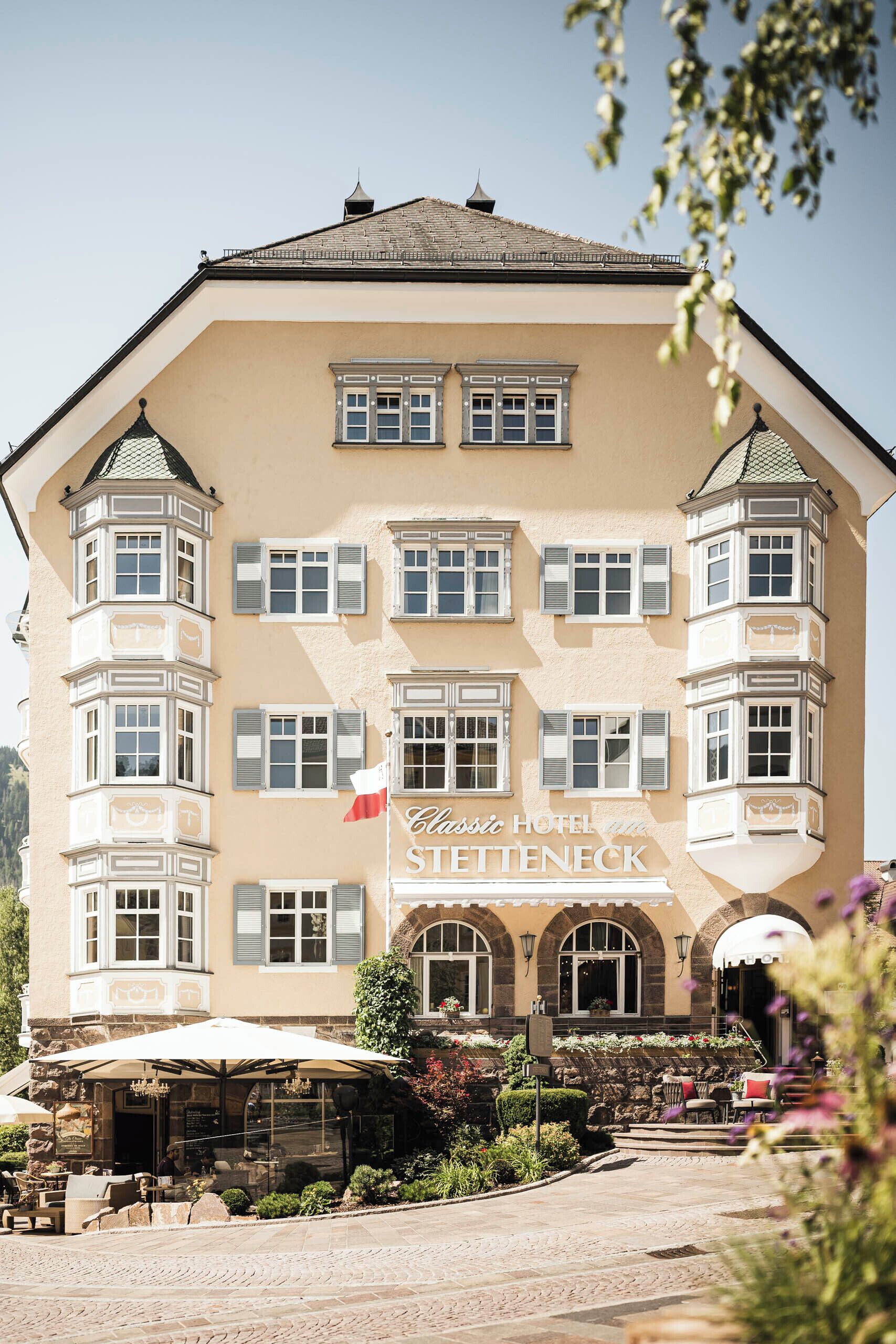 A Classic Hotel Stettenneck with a traditional facade, multiple windows, and a stone entrance.