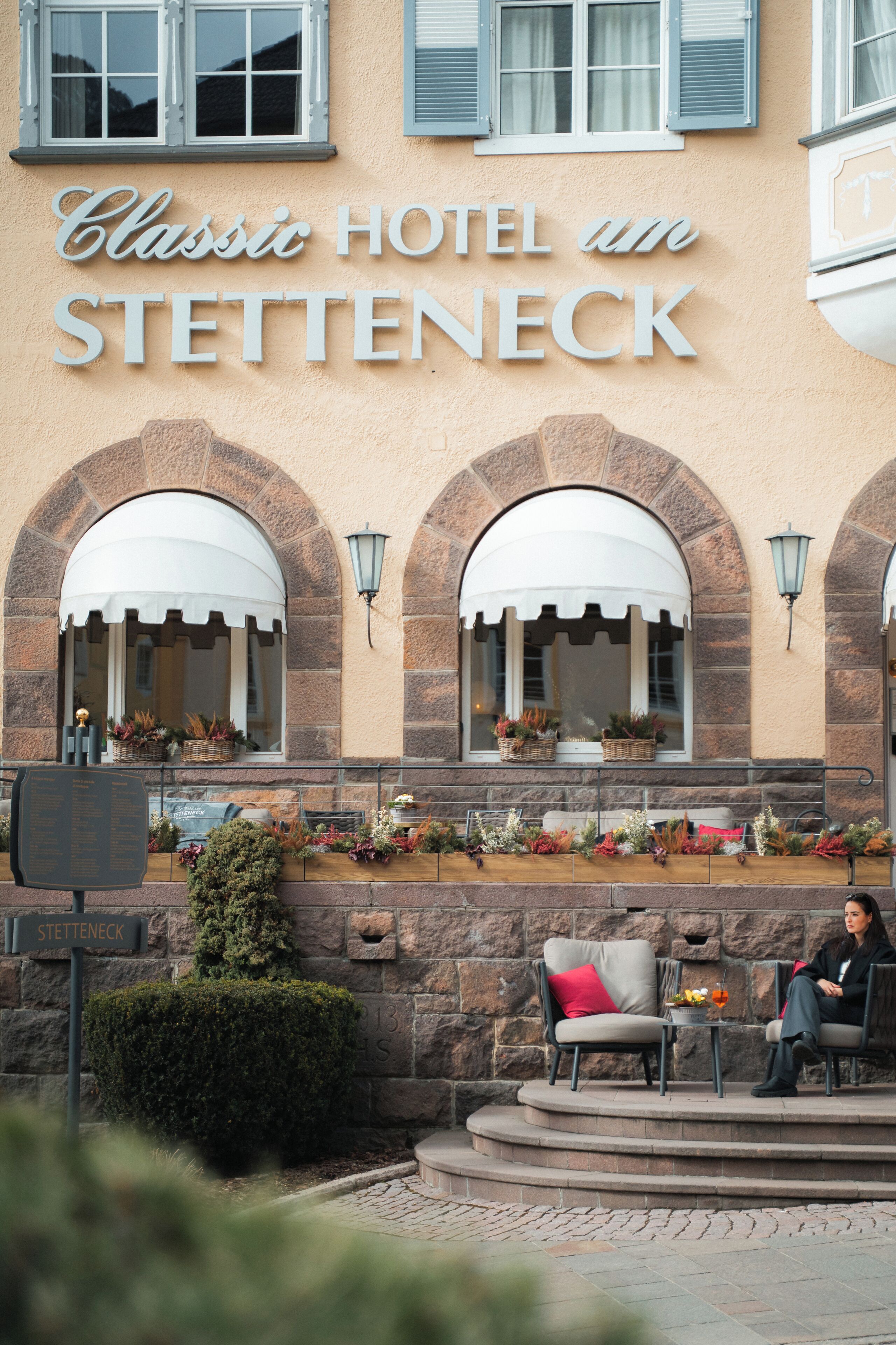 A Classic Hotel with arched windows and a sign above the entrance.