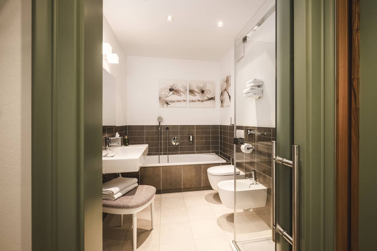 junior suite | bathroom | hair dryer, bathrobes, bidet, towels