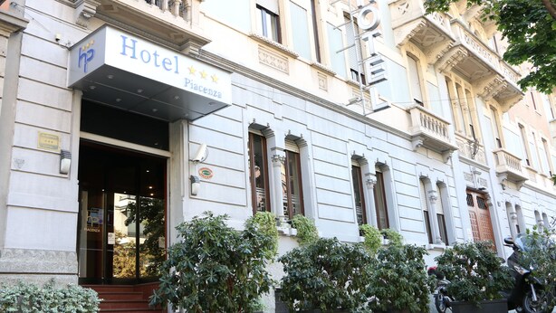 A hotel facade with a sign reading "Hotel Piacenza," featuring classical architecture with columns and decorative moldings. - Hotel Piacenza (Milan)