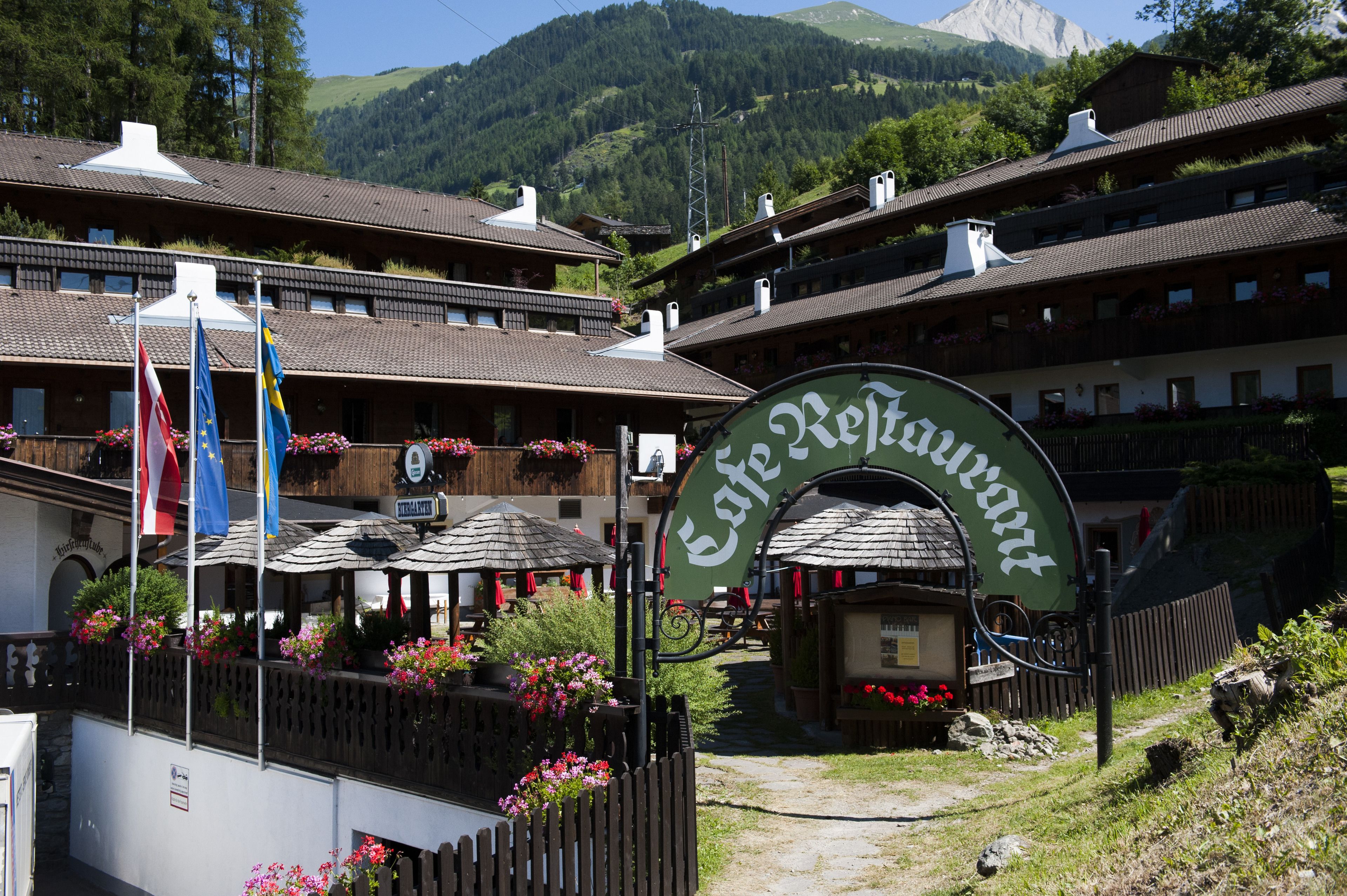 A traditional Alpine-style building with a sign reading "Cafe Restaurant."