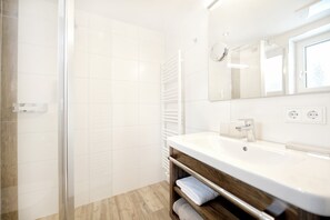 Junior Suite, Balcony, Mountain View (Valluga) | Bathroom | Hair dryer, bathrobes, towels, soap - Hotel Alpina Arlberg (Pettneu am Arlberg)
